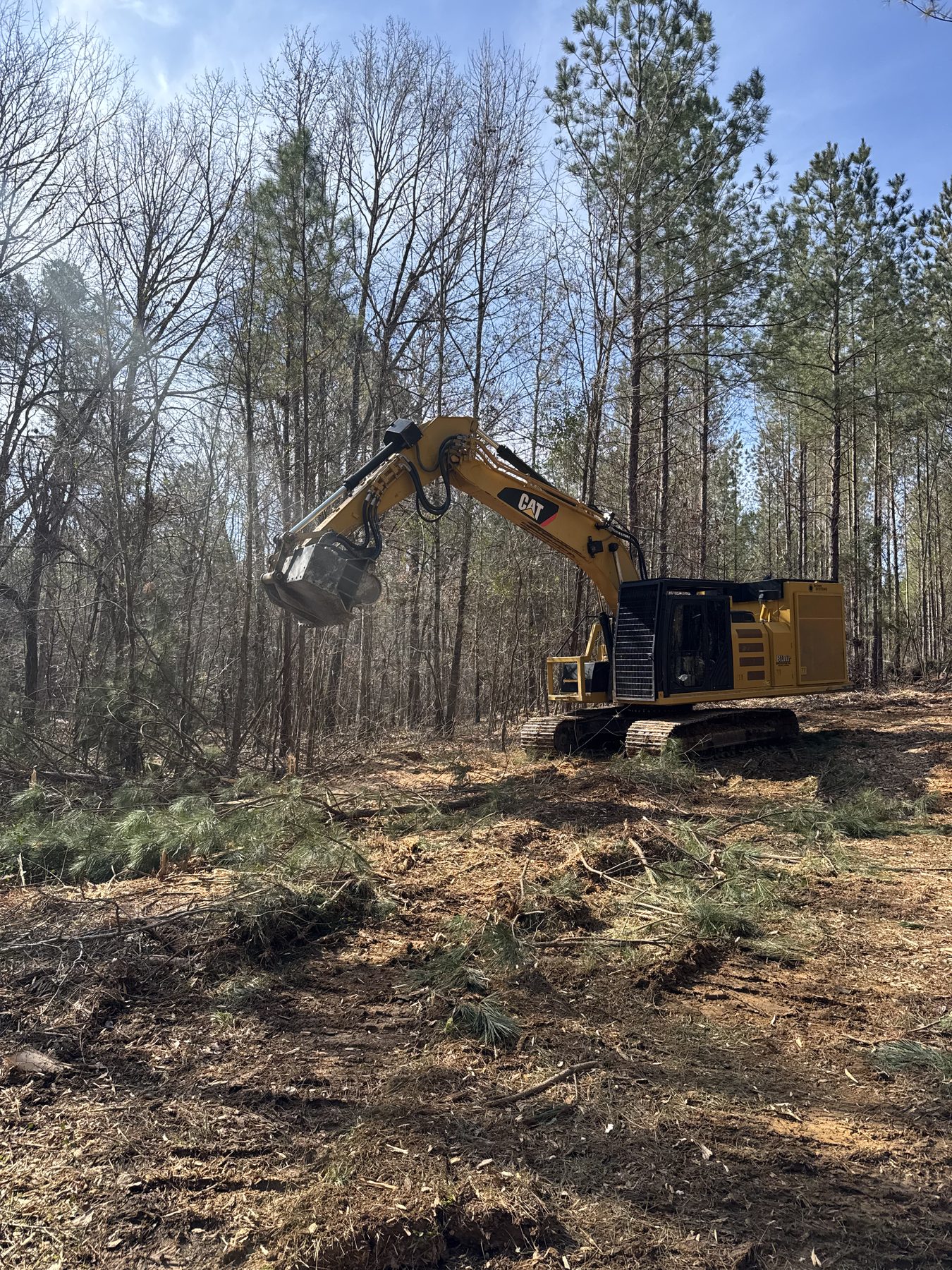Excavator being fueled on a gravel road job site